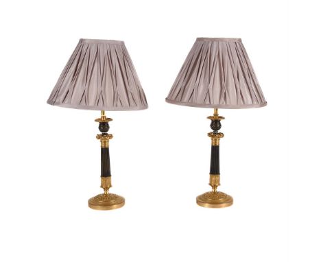 A PAIR OF GILT AND PATINATED METAL CANDLESTICKS  SECOND QUARTER 19TH CENTURY AND LATER CONVERTED TO ELECTRICITY  With a pair 