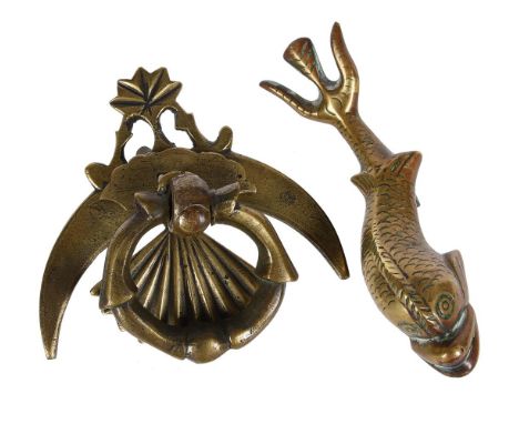 A SOLID BRASS DOOR KNOCKER  PROBABLY MALTESE,  LATE 19TH OR EARLY 20TH CENTURY  In the form of a dolphin 19.5cm highTogether 