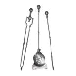 A SET OF THREE POLISHED STEEL FIRE TOOLS