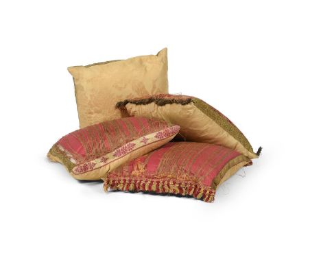 A GROUP OF FOUR CUSHIONS COVERED IN GOLD DAMASK  20TH CENTURY  Each with gold braid edging  Approximately 50 x 50cm And anoth