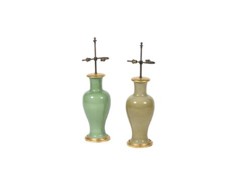 A MATCHED PAIR OF GREEN GLAZED PORCELAIN AND GILTWOOD MOUNTED TABLE LAMPS   20TH CENTURY  Fitted for electricity  bases 53cm 