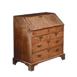 A GEORGE II WALNUT AND CROSS BANDED BUREAU