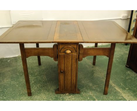 An Art Deco oak dropleaf pembroke style table, the central pedestal desk with cupboards below drawers, by Lebus, c1940, 152 x