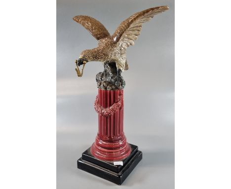 Ceramic novelty pocket watch/clock holder in the form of an eagle with outstretched wings standing on a classical fluted Cori