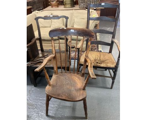 19th century ladder backed elbow chair with rush seat, a late late 19th century stick backed fireside elbow chair with elm se