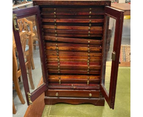 Edwardian mahogany coin collector's cabinet having two glazed doors revealing multiple fitted drawers to the interior and wit