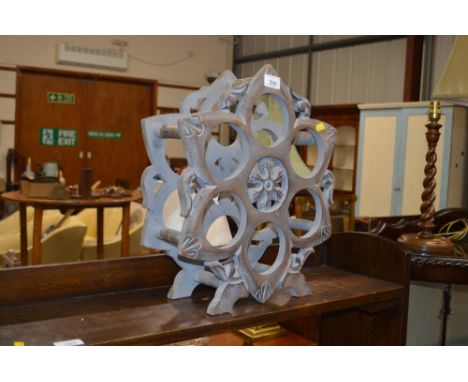 A grey painted wooden wine rack