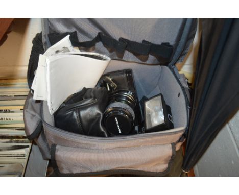 A camera bag containing a Praktica camera, a Miranda flash etc. 