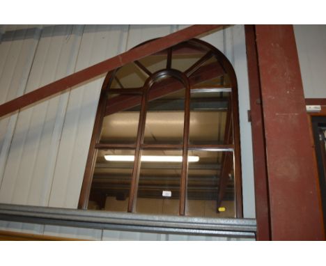 An arch framed sectional wall mirror