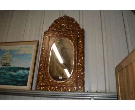 An Eastern hard wood, brass and mother of pearl inlaid mirror