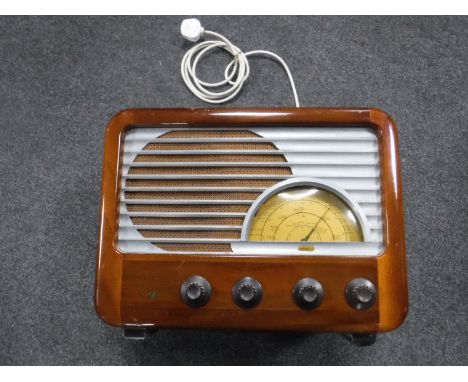 A mid 20th century mahogany cased valve radio, a Pifco lamp and a bike light 