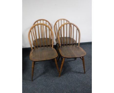 A set of four Ercol elm dining chairs 