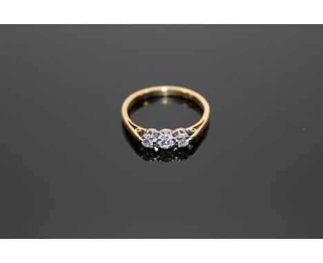 An 18ct gold three stone diamond ring