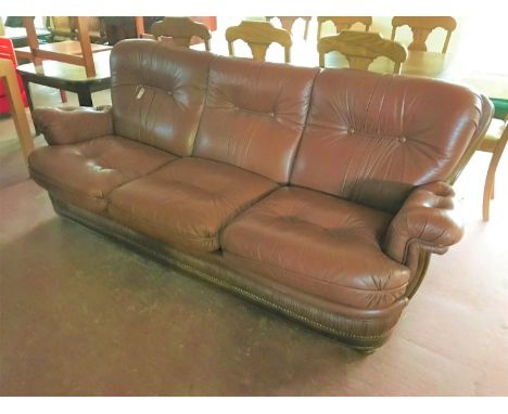 A brown leather button leather three seater settee