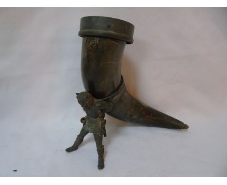 Vintage drinking horn with a metal figure of a gentleman
