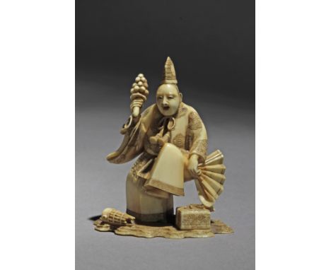 Signed Yoshiaki on the base. In carved elephant tusk portraying Sambaso dancing on one leg,, while holding bells with his rig
