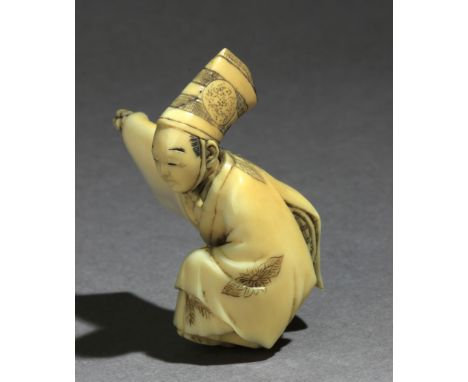 Signed Gyokko on the base. In carved ivory tusk portraying a dancing Sambaso with a jointed head, coveredby a top hat and hol