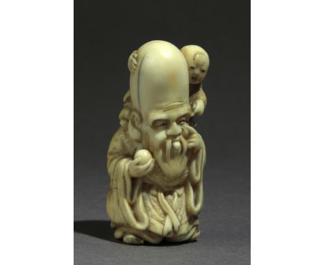 Signed Issen on the base. In carved elephant tusk portraying a standing Fukurokuju bringinf a ball and carrying a child over 