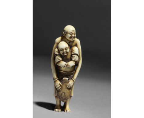 Signed Kogetsu on the back. In carved elephant tusk portraying a pair of fishermen, a standing 'Ashinaga' carrying 'Tenaga' o