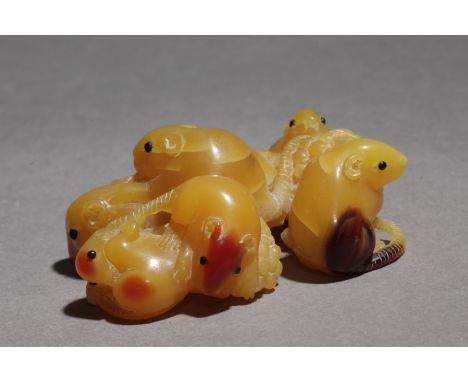 Signed Tomokazu on the base. In carved hornbill and horn eyes inlaid portraying a group of six rats eating grapes, 40,4x48,2x