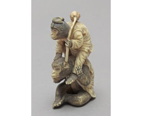 Not signed. In carved elephant tusk portraying a pair of monkeys, the female dressed as a woman and sat over the male, who is