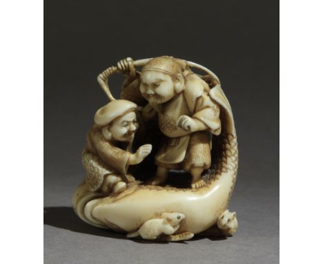 Signed Getsumada on the base. In carved elephant tusk with details in horn portraying Ebisu and Daikoku over a gigant carp th