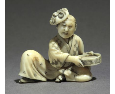 A mid 19th century Japanese netsuke from Meiji period. Signed ...gyoku on the base. In carved elephant tusk portraying a man 