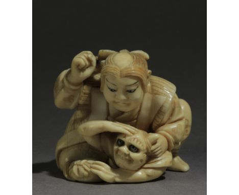 A Japanese netsuke circa 1900 from Meiji period. Signed Yosikazu on a red kanji on the back. In carved elephant tusk portrayi