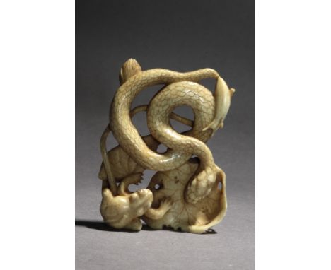 Signed Nobuchika Con Kakihan on the base. In carved elephant tusk portraying a group composed by a snake on a lotus leaf, rea