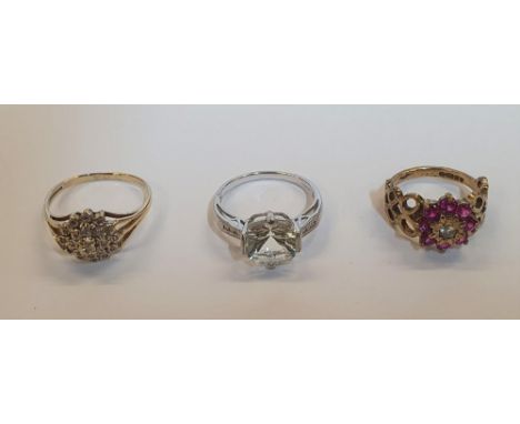 3 9ct gold rings (3) to include a large solitaire clear stone ring in white gold, a Ruby flower ring and another,Total gross 