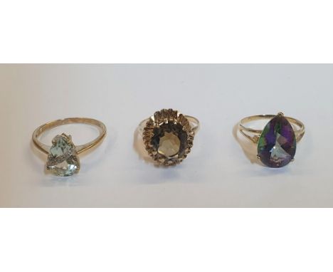 3, 9ct yellow gold rings (3), the first a large pear cut Topaz with diamond chips. the 2nd, a large Quartz ring and a pear cu