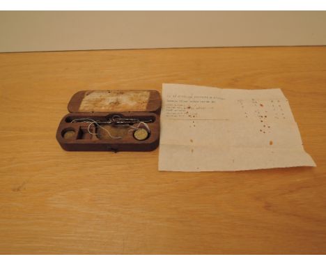 A Guinea Coin Scale and Weights in wooden box with label to inside of lid