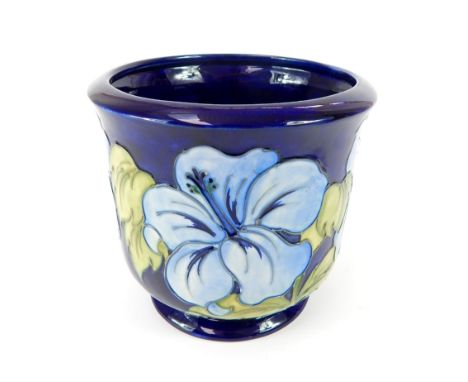 A William Moorcroft ‘Blue Anenomies’ on midnight blue ground, ceramic jardinière, 77.5x18cm dia.