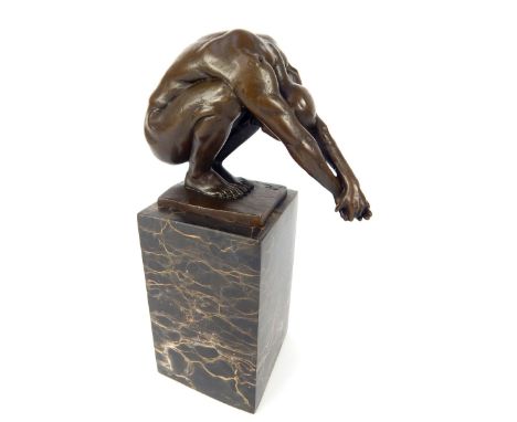 Bronze sculpture of an athletic man, in a yoga pose, black variegated plinth, overall 24cm h