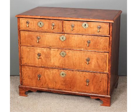 An 18th Century figured walnut chest of drawers, the crossbanded top with quartered matched veneer and boxwood stringing, fit