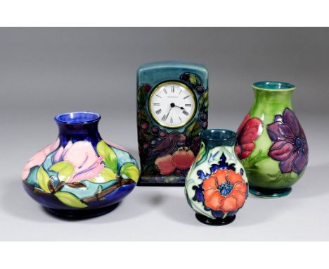 A modern Moorcroft pottery mantel timepiece, the rectangular case tube lined and decorated in colours with a bird and fruit, 