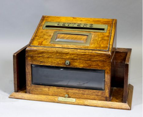 A late Victorian/early 20th Century oak and brass mounted "Hall" letter box, the sloping lid with brass flap worded "Letters"