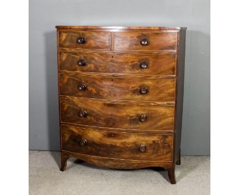 A late Georgian mahogany bow-front chest, fitted two short and four long drawers with turned knob handles, on splayed bracket