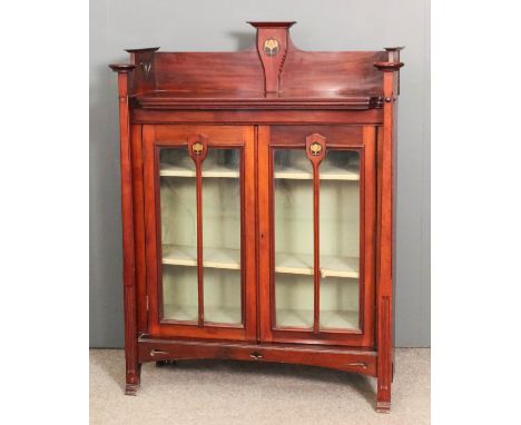An early 20th Century mahogany dwarf bookcase of Art Nouveau design with high pierced gallery, tapered front supports and wit