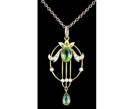 An Edwardian gold coloured metal mounted peridot and seed pearl set pendant, the oval open work panel set with a green garnet
