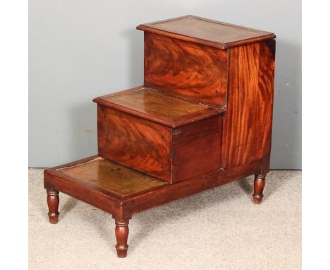 A 19th Century mahogany three tier library commode inlaid with ebonised stringing, the treads inset with green leather, on tu