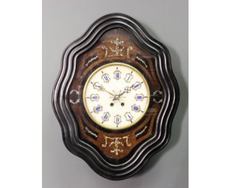 A 19th Century French ebonised cased oval wall clock, the 9.5ins diameter alabaster dial with raised enamel and gilt metal mo