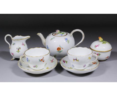 An early 20th Century Meissen porcelain part tea service enamelled in colours with Deutsche Blumen and with gilt rims, compri