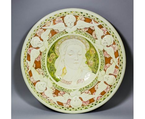 A fine Della Robbia pottery charger modelled by Ruth Bare with moulded and scraffito decoration of a central portrait of the 