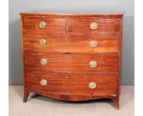 A late George III mahogany bow-front chest of drawers, the top with square edge inlaid with boxwood stringing, fitted two sho