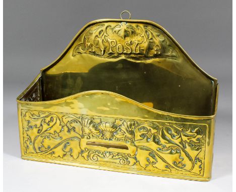 An Arts & Crafts brass rectangular post rack by W.H. Mawson of K.H.I., Keswick, embossed with thistles and leaves, 13ins x 4.