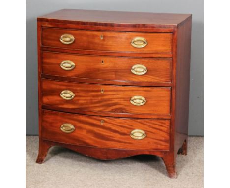 A late Georgian mahogany bow-front chest of drawers of small proportions with crossbanded top, fitted four long graduated dra