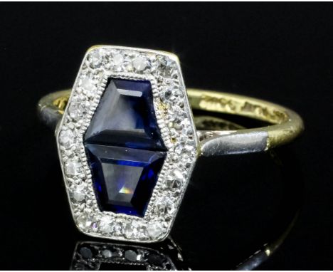 An Art Deco 18ct gold and platinum mounted sapphire and diamond dress ring, the face set with two sapphires (estimated diamon