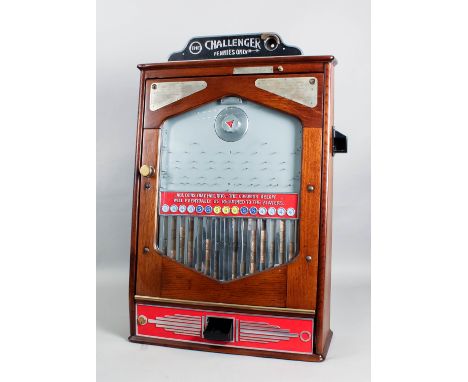 A 1950s Bradley's oak cased penny-in-the-slot gaming machine - "The Challenger", the mahogany front panel with fifteen slots 