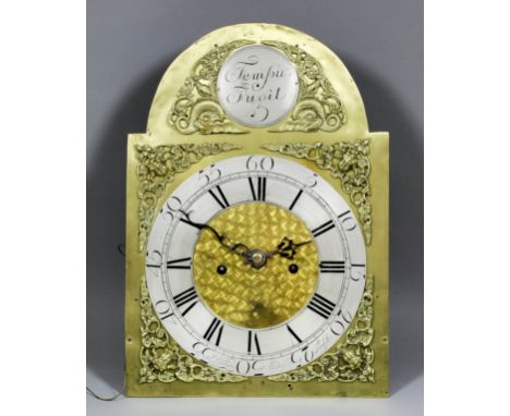 A longcase clock movement, the 12ins arched brass dial with silvered chapter ring with Roman and Arabic numerals and named "W